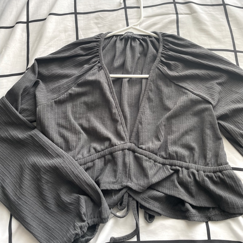 Long Sleeve Crop top with adjustable straps in the back. Sized Large